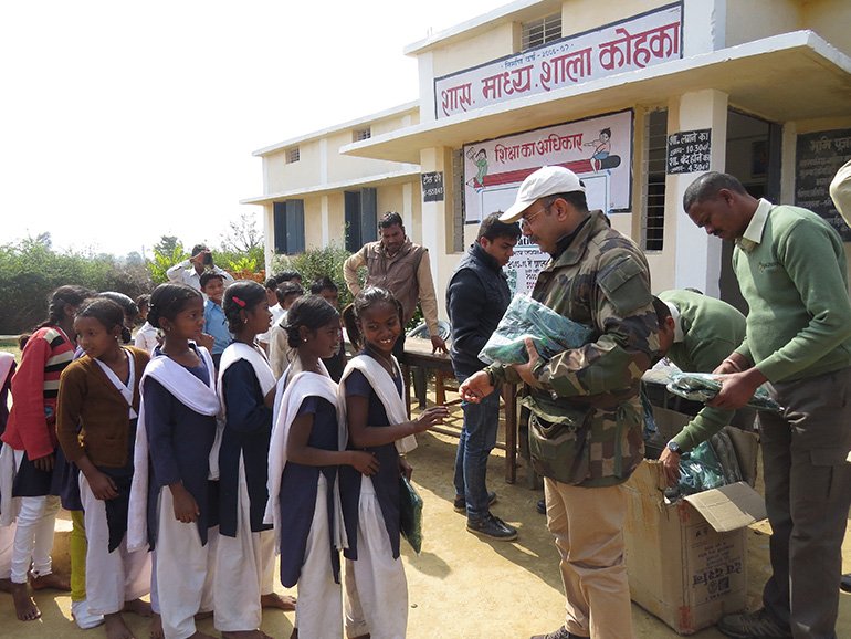 Distribution of sweaters to children at Kohka village school